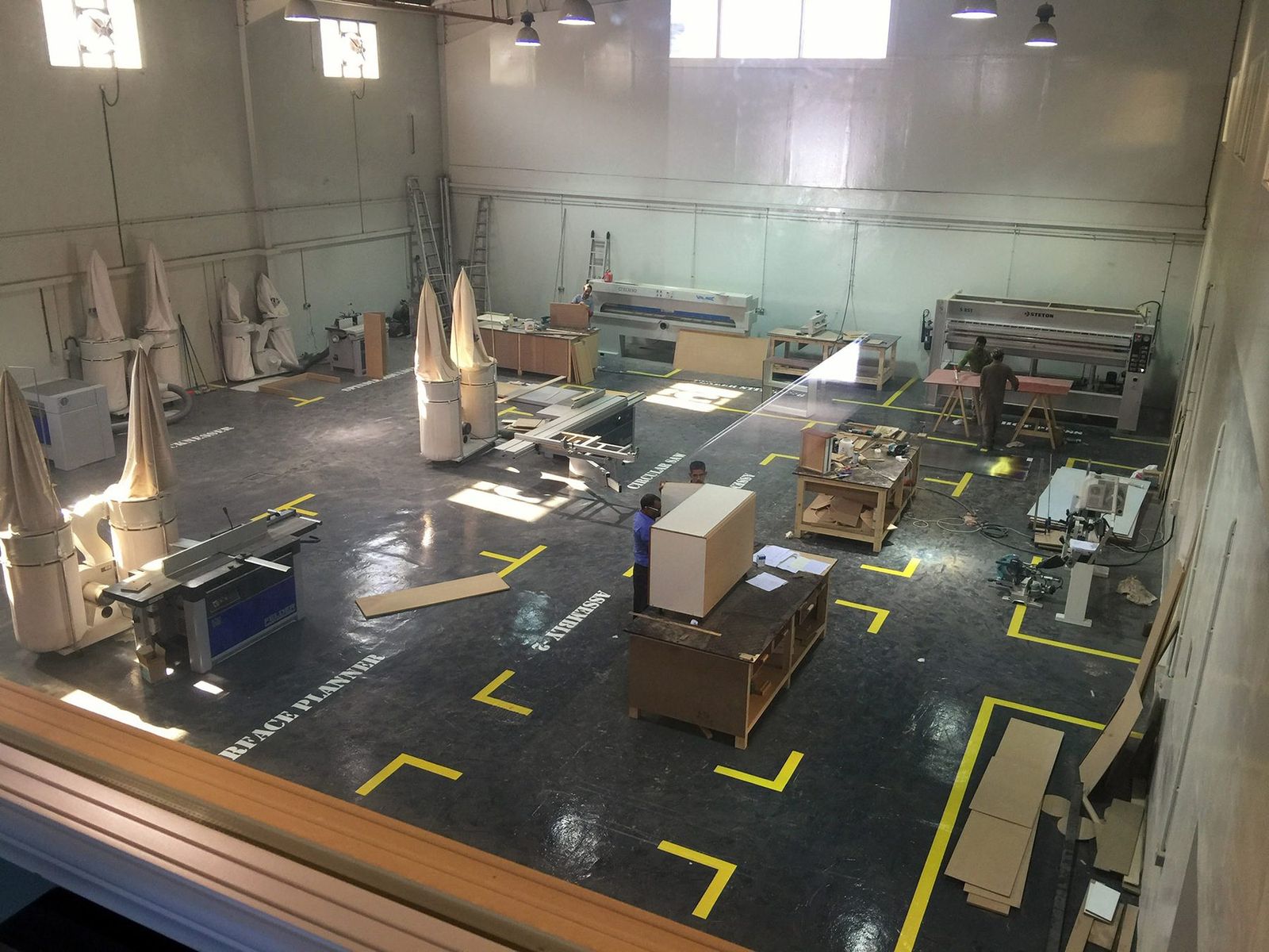 The joinery workshop floor with panel saws, planers and assembly benches