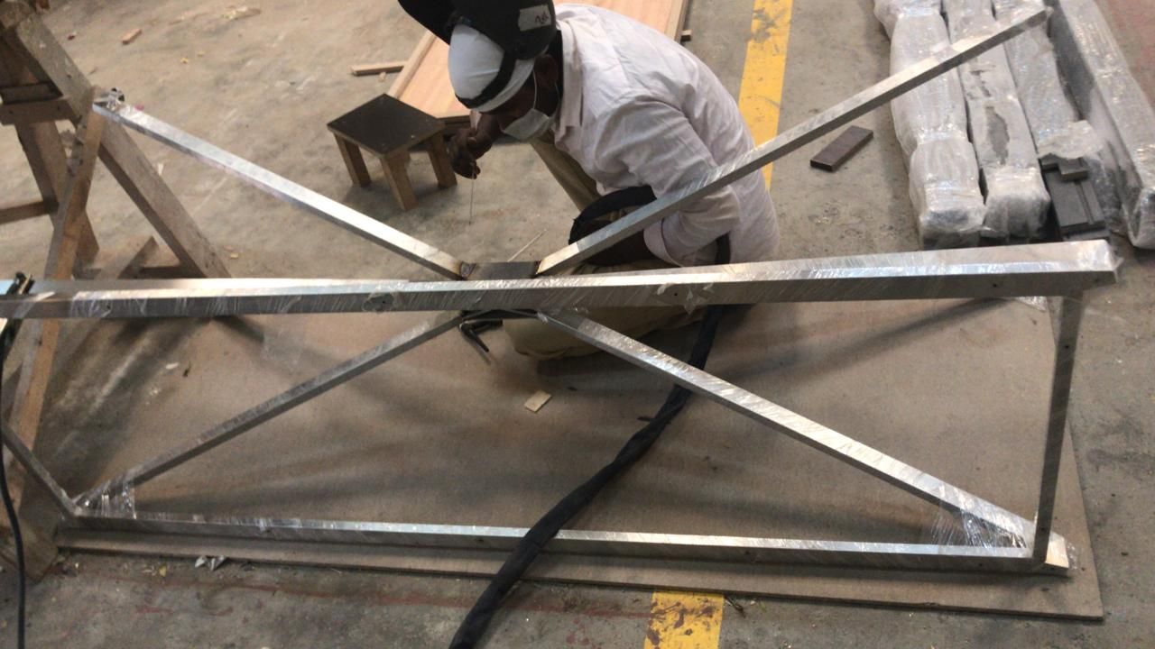 A metalworker welding a steel frame