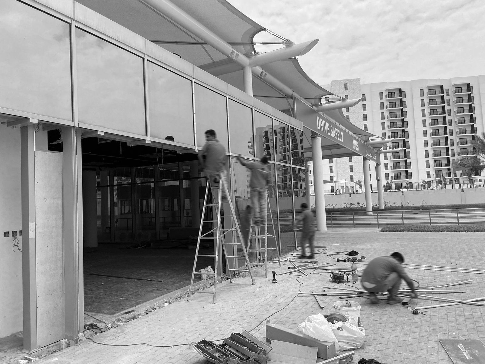 Site team fitting the showroom facade at Yas Marina Circuit